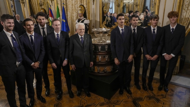 Italian President Sergio Mattarella, center, poses with members of the Italian winning team of the 2023 tennis Davis Cup and their staff next to the trophy at the end of a meeting in Rome's Quirinale Presidential Palace, Thursday, Feb. 1, 2024. From right are, JUannik Sinner, Matteo Arnaldi, Simone Bolelli and Lorenzo Sonego. (AP Photo/Andrew Medichini)