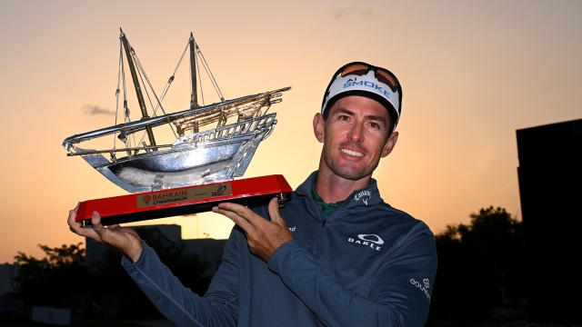 BAHRAIN, BAHRAIN - FEBRUARY 04: Dylan Frittelli of South Africa poses with the trophy as he celebrates victory following Day Four of the Ras Al Khaimah Championship at Royal Golf Club on February 04, 2024 in Bahrain, Bahrain. (Photo by Ross Kinnaird/Getty Images)