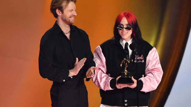 TOPSHOT - US singer-songwriter Billie Eilish (R) and US singer-songwriter Finneas O'Connell accept the Song Of The Year award for "What Was I Made For?" on stage during the 66th Annual Grammy Awards at the Crypto.com Arena in Los Angeles on February 4, 2024. (Photo by Valerie Macon / AFP)
