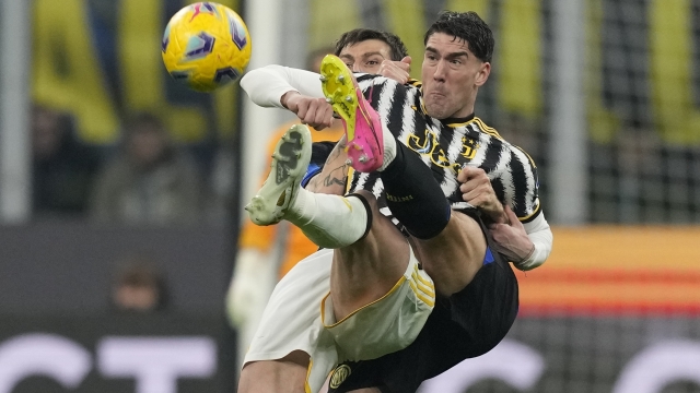 Inter Milan's Francesco Acerbi, left, and Juventus' Dusan Vlahovic fight for the ball during a Serie A soccer match between Inter Milan and Juventus, in Milan, Italy, Sunday, Feb. 4, 2024. (AP Photo/Antonio Calanni)