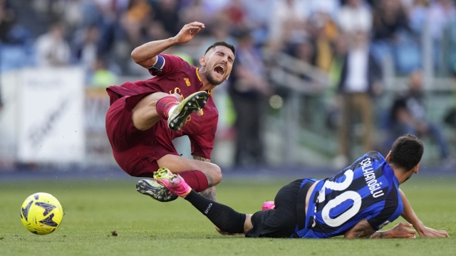 Roma's Lorenzo Pellegrini, left, challenges for the ball with Inter Milan's Hakan Calhanoglu during a Serie A soccer match between Roma and Inter Milan, at Rome's Olympic Stadium, Saturday, May 6, 2023. (AP Photo/Andrew Medichini)