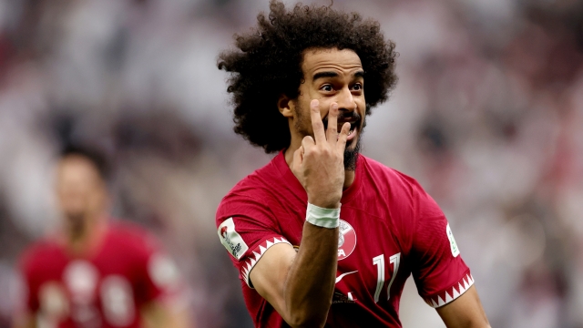 LUSAIL CITY, QATAR - FEBRUARY 10: Akram Afif of Qatar celebrates scoring his team's third goal and hat trick from the penalty spot during the AFC Asian Cup final match between Jordan and Qatar at Lusail Stadium on February 10, 2024 in Lusail City, Qatar. (Photo by Robert Cianflone/Getty Images)