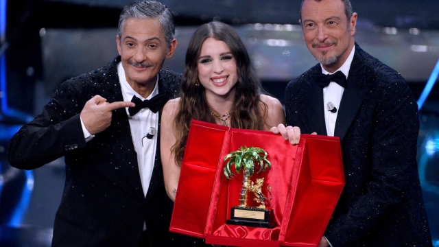 Angelina Mango (C) with the trophy after winning the Sanremo Italian Song Festival with Sanremo Festival host and artistic director Amadeus (R) and Sanremo Festival co-host and Italian showman Rosario Fiorello (L) on stage at the Ariston theatre during the 74th Sanremo Italian Song Festival, Sanremo, Italy, 10 February 2024. The music festival will run from 06 to 10 February 2024. ANSA/ETTORE FERRARI