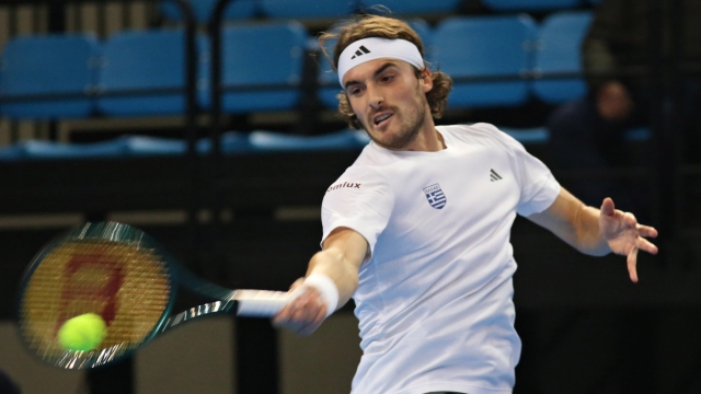 epa11124290 Stefanos Tsitsipas of Greece in action against Marius Copil of Romania during the Davis Cup World Group play off tie Greece vs Romania  at Ano Liossia Olympic Hall, Athens, Greece, 03 February 2024.  EPA/BELTES ALEXANDROS