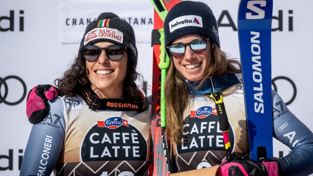 Second placed Italy's Federica Brignone (L) and winner Italy's Marta Bassino pose during the podium ceremony of the Women's downhill event at the FIS Alpine Ski World Cup in Crans-Montana, Switzerland, on February 17, 2024. (Photo by Fabrice COFFRINI / AFP)