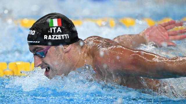 Italy's Alberto Razzetti competes in a heat of the men's 400m individual medley swimming event during the 2024 World Aquatics Championships at Aspire Dome in Doha on February 18, 2024. (Photo by SEBASTIEN BOZON / AFP)