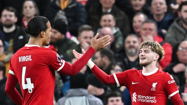 Liverpool's English midfielder #19 Harvey Elliott (R) celebrates with Liverpool's Dutch defender #04 Virgil van Dijk after scoring his team fourth goal during the English Premier League football match between Liverpool and Luton Town at Anfield in Liverpool, north west England on February 21, 2024. (Photo by Paul ELLIS / AFP) / RESTRICTED TO EDITORIAL USE. No use with unauthorized audio, video, data, fixture lists, club/league logos or 'live' services. Online in-match use limited to 120 images. An additional 40 images may be used in extra time. No video emulation. Social media in-match use limited to 120 images. An additional 40 images may be used in extra time. No use in betting publications, games or single club/league/player publications. /