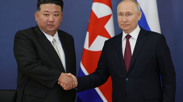 (FILES) This pool image distributed by Sputnik agency shows Russian President Vladimir Putin (R) and North Korea's leader Kim Jong Un (L) shaking hands during their meeting at the Vostochny Cosmodrome in Amur region on September 13, 2023. North Korea's top diplomat said her country is "ready to greet" Russian President Vladimir Putin, state media reported on January 21, 2024, in the latest sign of deepening ties between the two authoritarian states. (Photo by Vladimir SMIRNOV / POOL / AFP)