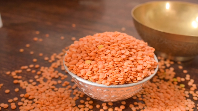 Dry Split Red Lentils in a Silver bowl on wooden old Table. rustic style