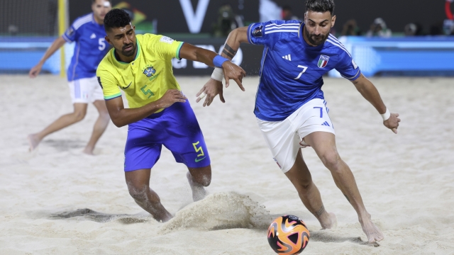 Filipe of Brazil and Fabio Sciacca competes for the ball during the FIFA Beach Soccer World Cup UAE 2024 final match between Brazil and Italy at the Dubai Design District Stadium in Dubai, United Arab Emirates, Sunday, Feb. 25, 2024. (AP Photo/Christopher Pike)