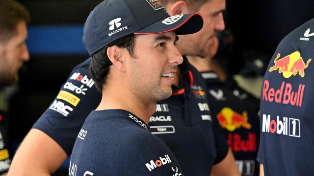 Red Bull Racing's Mexican driver Sergio Perez talks to his engineers during the third day of the Formula One pre-season testing at the Bahrain International Circuit in Sakhir on February 23, 2024. (Photo by Andrej ISAKOVIC / AFP)