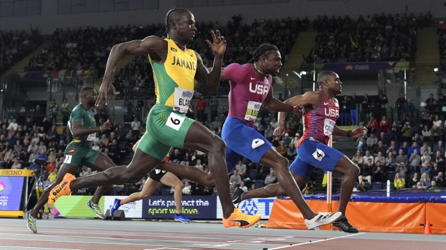 Gold medalist Christian Coleman, of the United States, Silver medalist Noah Lyles, of the United States, and bronze medalist Ackeem Blake, of Jamaica, from right to left, cross the finish line in the men's 60 meters final during the World Athletics Indoor Championships at the Emirates Arena in Glasgow, Scotland, Friday, March 1, 2024. (AP Photo/Bernat Armangue)