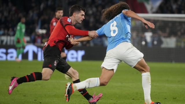 AC Milan's Christian Pulisic, left, stops Lazio's Matteo Guendouzi during the Italian Serie A soccer match between Lazio and Milan at Rome's Olympic stadium, Friday, March 1, 2024. (AP Photo/Gregorio Borgia)    Associated Press / LaPresse Only italy and Spain