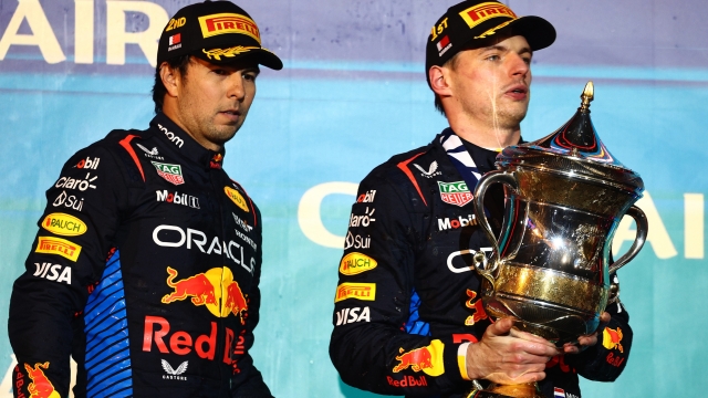 BAHRAIN, BAHRAIN - MARCH 02: Race winner Max Verstappen of the Netherlands and Oracle Red Bull Racing and Second placed Sergio Perez of Mexico driving the (11) Oracle Red Bull Racing RB20 celebrate on the podium during the F1 Grand Prix of Bahrain at Bahrain International Circuit on March 02, 2024 in Bahrain, Bahrain. (Photo by Clive Rose/Getty Images)