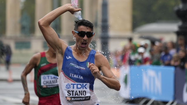 Massimo Stano, of Italy, cools down as he competes in the Men's 20-kilometer race walk the during the World Athletics Championships in Budapest, Hungary, Saturday, Aug. 19, 2023. (AP Photo/Ashley Landis)