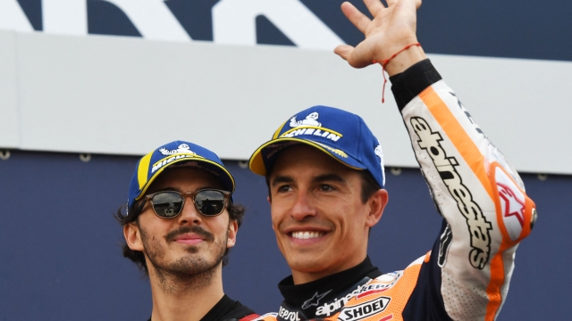 First placed Ducati Italian rider Francesco Bagnaia (L) and second placed Repsol Honda Team's Spanish rider Marc Marquez celebrate after the qualifying rounds ahead of the French Moto GP Grand Prix, at the Bugatti circuit in Le Mans, northwestern France, on May 13, 2023. (Photo by Jean-Francois MONIER / AFP)