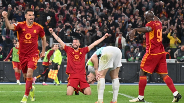 Roma's Italian midfielder #04 Bryan Cristante (2L) kneels on the ground as he celebrates scoring Roma's fourth goal during the UEFA Europe League last 16 first leg football match between AS Roma and Brighton and Hove Albion at the Olympic Stadium in Rome on March 7, 2024. (Photo by Andreas SOLARO / AFP)