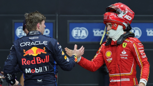 Pole position qualifier Red Bull Racing's Dutch driver Max Verstappen and second placed Ferrari's Monegasque driver Charles Leclerc shake hands after the qualifying session of the Saudi Arabian Formula One Grand Prix at the Jeddah Corniche Circuit in Jeddah on March 8, 2024. (Photo by Giuseppe CACACE / AFP)