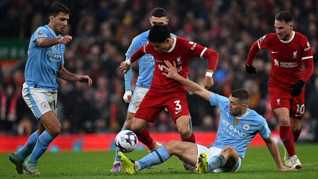 Manchester City's Croatian midfielder #08 Mateo Kovacic (2R) vies with Liverpool's Japanese midfielder #03 Wataru Endo (C) during the English Premier League football match between Liverpool and Manchester City at Anfield in Liverpool, north west England on March 10, 2024. (Photo by Paul ELLIS / AFP) / RESTRICTED TO EDITORIAL USE. No use with unauthorized audio, video, data, fixture lists, club/league logos or 'live' services. Online in-match use limited to 120 images. An additional 40 images may be used in extra time. No video emulation. Social media in-match use limited to 120 images. An additional 40 images may be used in extra time. No use in betting publications, games or single club/league/player publications. /