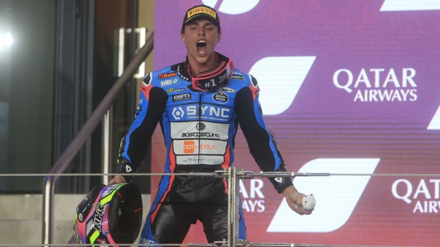 Race winner Spain's rider Alonso Lopez of the SpeedUp Racing celebrates on the podium after the Moto2 race of the Qatar Motorcycle Grand Prix, at the Lusail International Circuit in Doha, Qatar, Sunday, March 10, 2024. (AP Photo/Hussein Sayed)