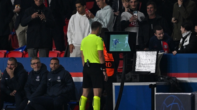PARIS, FRANCE - OCTOBER 25: Referee Slavko Vincic uses the VAR on-field monitor to review and disallow a goal scored by Ousmane Dembele of Paris Saint-Germain during the UEFA Champions League match between Paris Saint-Germain and AC Milan at Parc des Princes on October 25, 2023 in Paris, France. (Photo by David Ramos/Getty Images)