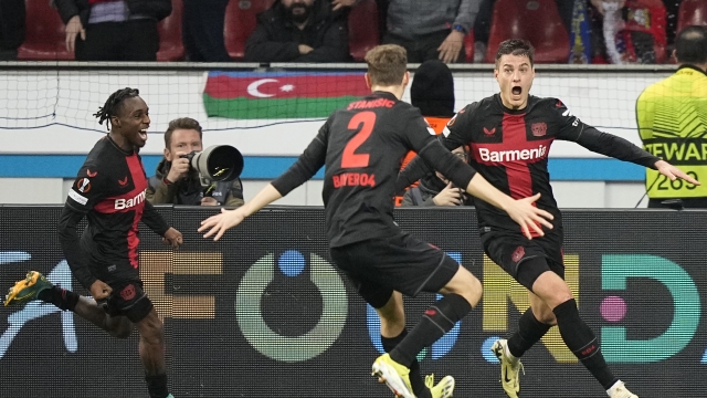 Leverkusen's Patrik Schick, right, celebrates after scoring his side's third goal during the Europa League round of sixteen, second leg, soccer match between Bayer Leverkusen and Qarabag FK at the BayArena in Leverkusen, Germany, Thursday, March 14, 2024. (AP Photo/Martin Meissner)
