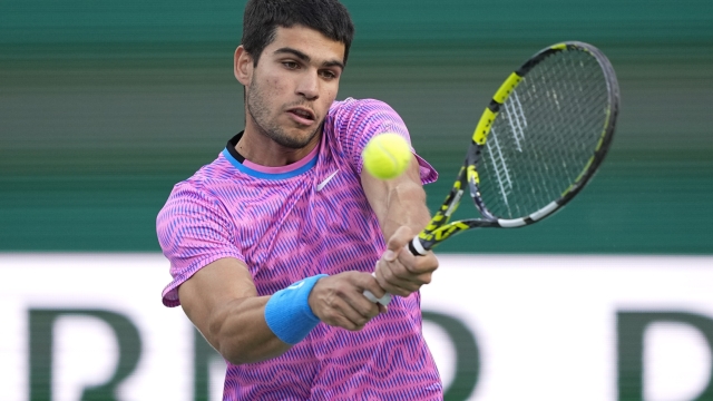 Carlos Alcaraz, of Spain, returns to Alexander Zverev, of Germany, during a quarterfinal match at the BNP Paribas Open tennis tournament, Thursday, March 14, 2024, in Indian Wells, Calif. (AP Photo/Mark J. Terrill)