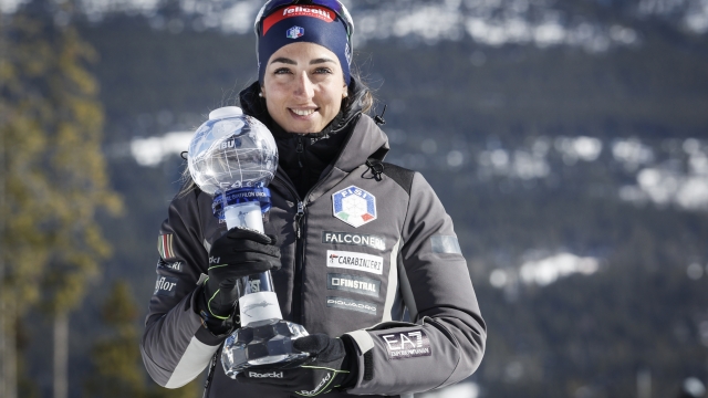 Italy's Lisa Vittozzi holds the biathlon trophy for Women's Individual World Cup score in Canmore, Alberta, Thursday, March 14, 2024. (Jeff McIntosh/The Canadian Press via AP)