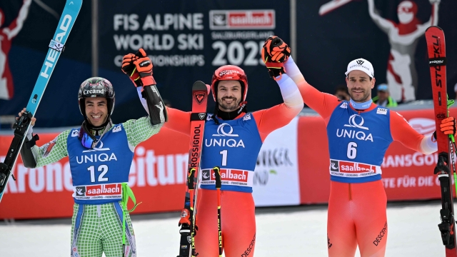 (L-R) Second placed Andorra's Joan Verdu, winner Switzerland's Loic Meillard and third placed Switzerland's Thomas Tumler celebrate after the men's Giant Slalom event of FIS Ski Alpine World Cup in Saalbach, Austria on March 16, 2024. (Photo by Joe Klamar / AFP)