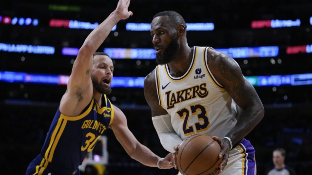 Golden State Warriors guard Stephen Curry (30) defends against Los Angeles Lakers forward LeBron James (23) during the second half of an NBA basketball game in Los Angeles, Saturday, March 16, 2024. (AP Photo/Ashley Landis)