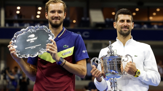 (FILES) Serbia's Novak Djokovic (R) poses with the trophy after defeating Russia's Daniil Medvedev (L) during the US Open tennis tournament men's singles final match at the USTA Billie Jean King National Tennis Center in New York City, on September 10, 2023. (Photo by kena betancur / AFP)