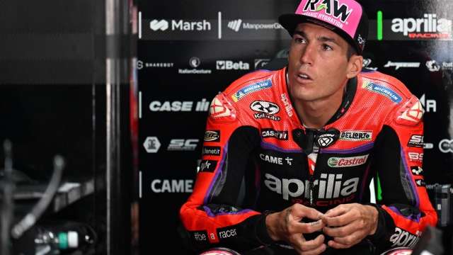 Aprilia Racing's Spanish rider Aleix Espargaro sits in the garage before the second free practice session ahead of the Indian MotoGP Grand Prix at the Buddh International Circuit in Greater Noida on the outskirts of New Delhi, on September 23, 2023. (Photo by Money SHARMA / AFP)