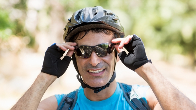 Portrait of a man bike rider smiling on the wood