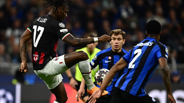 AC Milan's Portuguese forward Rafael Leao (L) challenges Inter Milan's Italian midfielder Nicolo Barella during the UEFA Champions League semi-final second leg football match between Inter Milan and AC Milan on May 16, 2023 at tyhe Giuseppe-Meazza (San Siro) stadium in Milan. (Photo by GABRIEL BOUYS / AFP)