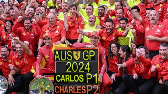 Winner Ferrari's Spanish driver Carlos Sainz Jr (front centre L) and second-placed Ferrari's Monegasque driver Charles Leclerc (front centre R) celebrate with their team after the Australian Formula One Grand Prix at Albert Park Circuit in Melbourne on March 24, 2024. (Photo by WILLIAM WEST / AFP) / -- IMAGE RESTRICTED TO EDITORIAL USE - STRICTLY NO COMMERCIAL USE --