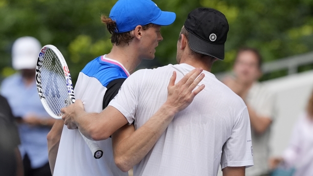 Jannik Sinner, left, of Italy, meets Tallon Griekspoor, right, of the Netherlands, at the net after winning their match during the Miami Open tennis tournament, Sunday, March 24, 2024, in Miami Gardens, Fla. (AP Photo/Lynne Sladky)