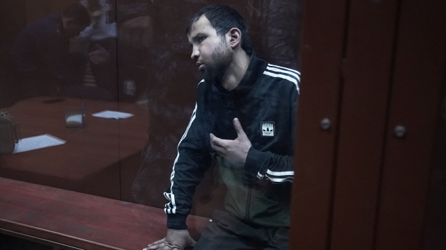 A man suspected of taking part in the attack of a concert hall that killed 137 people, the deadliest attack in Europe to have been claimed by the Islamic State jihadist group, sits inside the defendant cage as he waits for his pre-trial detention hearing at the Basmanny District Court in Moscow on March 25, 2024. At least 137 people, including three children, were killed when camouflaged gunmen stormed the Crocus City Hall, in Moscow's northern suburb of Krasnogorsk, and then set fire to the building on March 22 evening. (Photo by TATYANA MAKEYEVA / AFP)