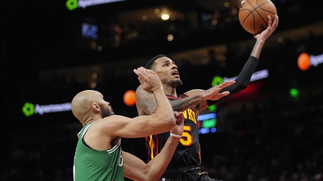 Atlanta Hawks guard Dejounte Murray (5) goes in for a shot as Boston Celtics guard Derrick White (9) defends during the first half of an NBA basketball game Thursday, March 28, 2024, in Atlanta. (AP Photo/John Bazemore)