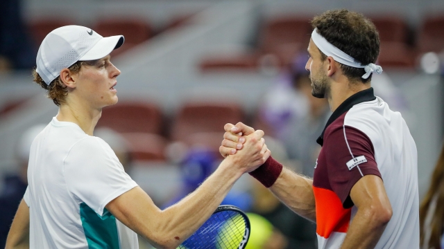 epa10895860 Jannik Sinner (L) of Italy and Grigor Dimitrov (R) of Bulgaria shake hands after their quarter-final match in the China Open tennis tournament in Beijing, China, 02 October 2023.  EPA/MARK R. CRISTINO