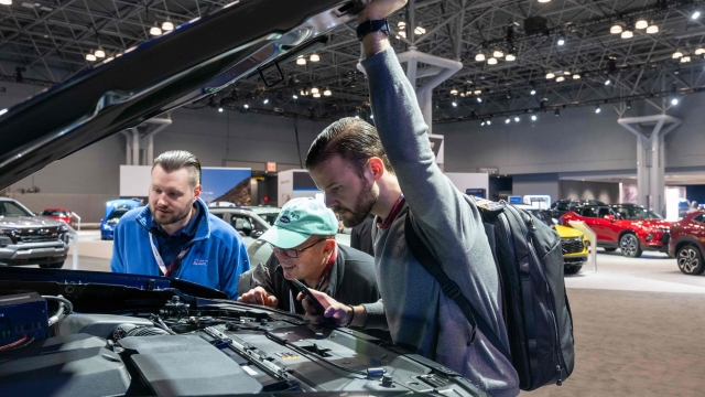 NEW YORK, NEW YORK - MARCH 27: Men look under the hood of a Chevrolet truck at the New York International Auto Show on March 27, 2024 in New York City. The annual show, which opens to the public on March 29th, is one of the largest auto shows in the world and reveals numerous new car models for both the public and the media. This year's show includes an emphasis on new electric and hybrid models.   Spencer Platt/Getty Images/AFP (Photo by SPENCER PLATT / GETTY IMAGES NORTH AMERICA / Getty Images via AFP)