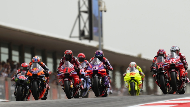 MotoGP riders Francesco Bagnaia of Italy, center left, and Jorge Martin of Spain, center right, steer their motorcycles at the start of the MotoGP race of the Portuguese Motorcycle Grand Prix at the Algarve International circuit near Portimao, Portugal, Sunday, March 24, 2024. (AP Photo/Jose Breton)