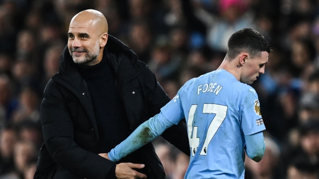 Manchester City's Spanish manager Pep Guardiola (L) congratulates Manchester City's English midfielder #47 Phil Foden as he leaves the pitch during the English Premier League football match between Manchester City and Aston Villa at the Etihad Stadium in Manchester, north west England, on April 3, 2024. (Photo by Paul ELLIS / AFP) / RESTRICTED TO EDITORIAL USE. No use with unauthorized audio, video, data, fixture lists, club/league logos or 'live' services. Online in-match use limited to 120 images. An additional 40 images may be used in extra time. No video emulation. Social media in-match use limited to 120 images. An additional 40 images may be used in extra time. No use in betting publications, games or single club/league/player publications. /