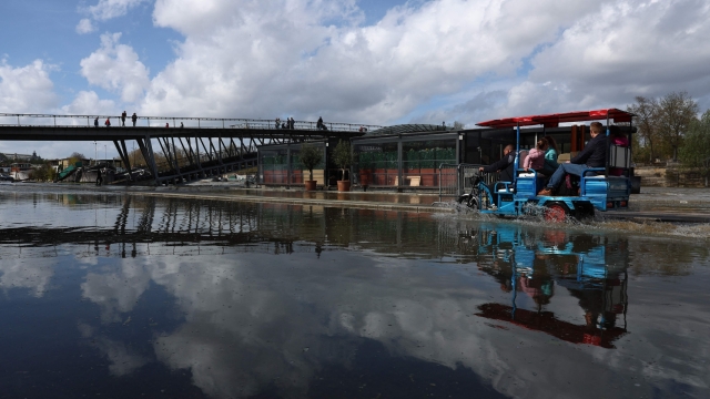 A man drives an auto rickshaw, better known as a tuk-tuk vehicle on the flooded docks along the Seine river, near the Passerelle Leopold-Sedar-Senghor bridge in Paris, on April 4, 2024. "On a national scale, the rainfall surplus was around 85 percent", compared with the 1991-2020 reference period, "i.e. the 5th wettest March since measurements began in 1958 (behind 2001, 1979, 1978 and 2006)", stated Meteo-France. (Photo by Emmanuel Dunand / AFP)