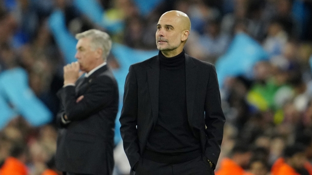 Manchester City's head coach Pep Guardiola and Real Madrid's head coach Carlo Ancelotti, left, stand by the touchline during the last minutes of the Champions League semifinal second leg soccer match between Manchester City and Real Madrid at Etihad stadium in Manchester, England, Wednesday, May 17, 2023. Manchester City won 4-0. (AP Photo/Jon Super)