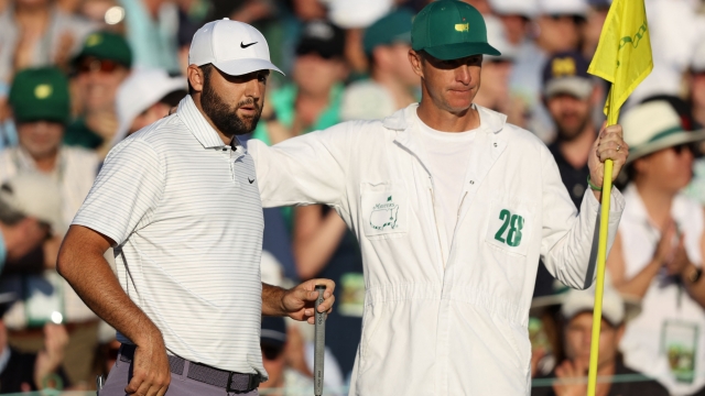 AUGUSTA, GEORGIA - APRIL 13: Scottie Scheffler of the United States and caddie Ted Scott line up a putt on the 18th green during the third round of the 2024 Masters Tournament at Augusta National Golf Club on April 13, 2024 in Augusta, Georgia.   Warren Little/Getty Images/AFP (Photo by Warren Little / GETTY IMAGES NORTH AMERICA / Getty Images via AFP)