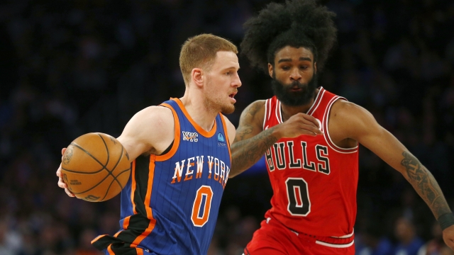 New York Knicks guard Donte DiVincenzo, left, dribbles past Chicago Bulls guard Coby White, right, during the first half of an NBA basketball game Sunday, April 14, 2024, in New York. (AP Photo/John Munson)