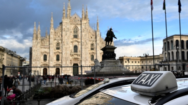 Taxi drivers wait in a taxi-stand in front of the Cathedral Duomo di Milano on Piazza del Duomo in Milan on March 6, 2024. Italy's competition watchdog was back at it again on March 6, 2024, calling on the peninsula's three main cities - Rome, Milan and Naples - to increase the number of cab licenses in order to put an end to "excessively long waiting times". (Photo by GABRIEL BOUYS / AFP)