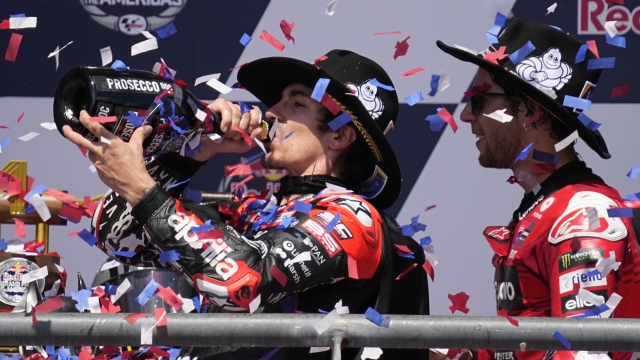 Winner Maverick Vinales, left, of Spain, celebrates with third-place finisher Enea Bastianini, right, of Italy, after competing in the MotoGP Grand Prix of the Americas motorcycle race at Circuit of the Americas, Sunday, April 14, 2024, in Austin, Texas. (AP Photo/Eric Gay)