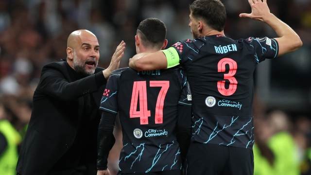 MADRID, SPAIN - APRIL 09: Pep Guardiola, Manager of Manchester City, celebrates with Phil Foden and Ruben Dias of Manchester City after Phil Foden scores his team's second goal  during the UEFA Champions League quarter-final first leg match between Real Madrid CF and Manchester City at Estadio Santiago Bernabeu on April 09, 2024 in Madrid, Spain. (Photo by Clive Brunskill/Getty Images) (Photo by Clive Brunskill/Getty Images)