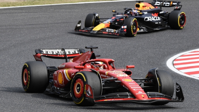 Ferrari's Monegasque driver Charles Leclerc (front) and Red Bull Racing's Dutch driver Max Verstappen (behind) take part in the Formula One Japanese Grand Prix race at the Suzuka circuit in Suzuka, Mie prefecture on April 7, 2024. (Photo by Toshifumi KITAMURA / AFP)